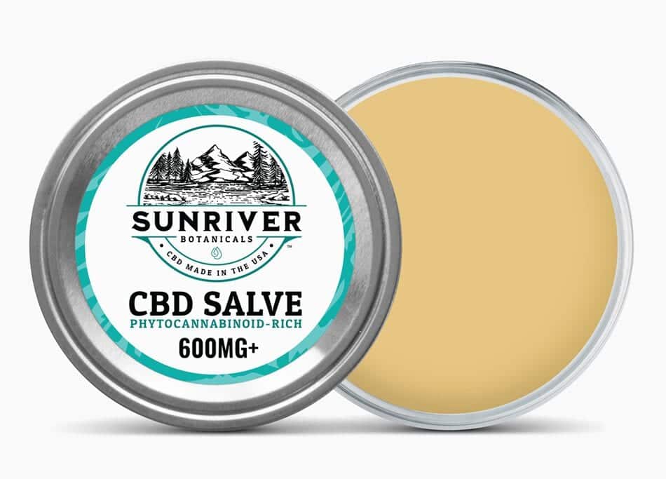 Open jar of Sunriver Botanicals CBD Salve 600mg resting on it's side with lid partially removed.