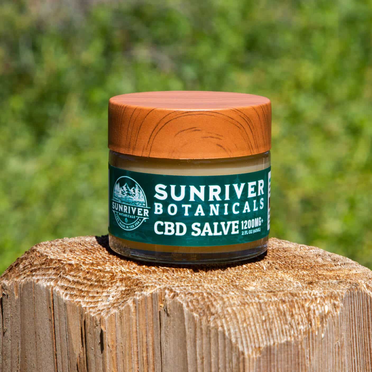 CBD Salve on a fence post in nature.