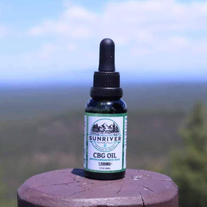 Sunriver Botanicals CBG Oil 1200 mg on a post in a park in Oregon.