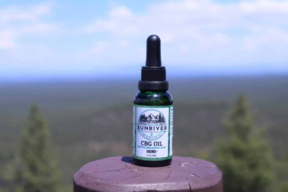Sunriver Botanicals CBG Oil 600 mg on a post in a park in Oregon.